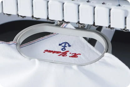 White embroidered handkerchief in small oval frame