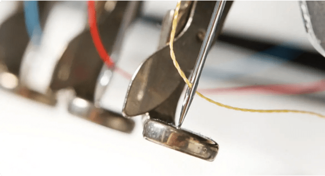 Extreme close up of embroidery machine needles